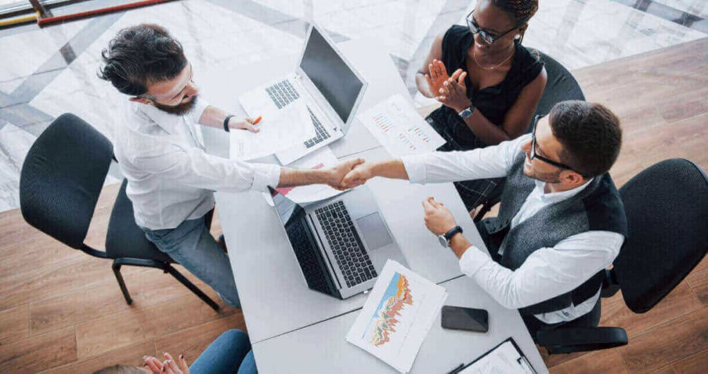 Business colleagues shaking hands after a successful meeting